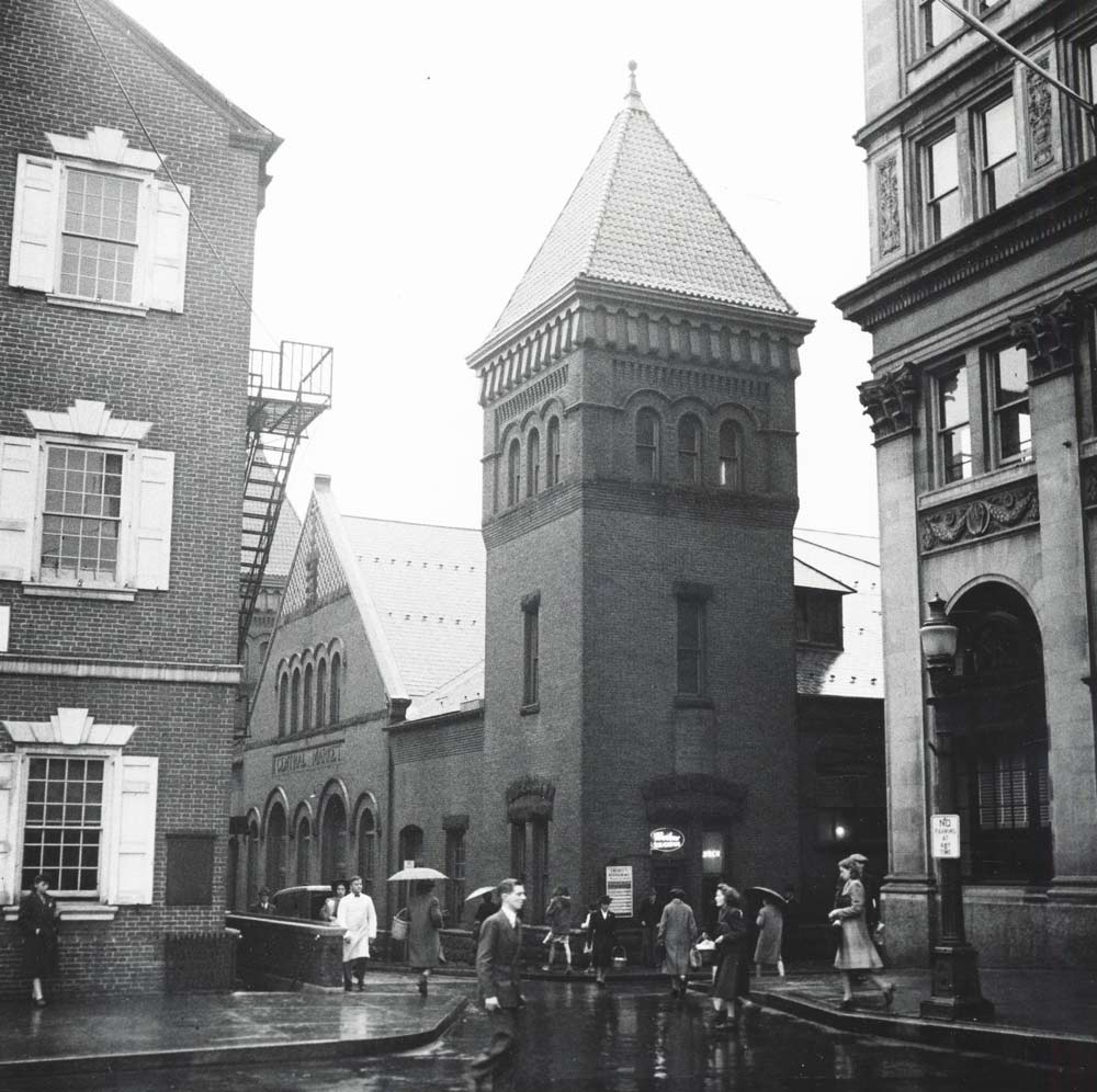 An-Impressive-Romanesque-Revival AN IMPRESSIVE ROMANESQUE REVIVAL</p>
<p>Market House, circa 1940. Photo courtesy of LancasterHistory.org.<br />
Not to be outdone by the rival, yet well-appointed, private markets that infiltrated Lancaster, the City entered into contract with English architect James Warner early in 1889. With an eye for simple grandeur, his official plan featured a red brick façade, two terracotta-topped towers, and an expansive slate roof.</p>
<p>The project began with a groundbreaking in June, and was completed just five months later in late Autumn. And since its dedication and reveal in November 1889, Lancaster Central Market has continued to welcome visitors each week to share in community fellowship, local commerce, and most importantly, a love for fresh, sustainable food excellence.